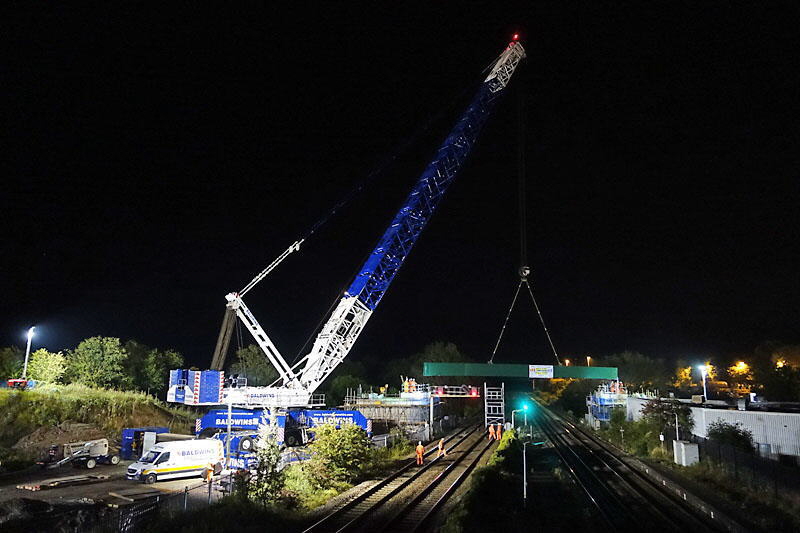 Lowering into place a side beam for the new bridge over The Gap Lowering into place a side beam for the new bridge over The Gap